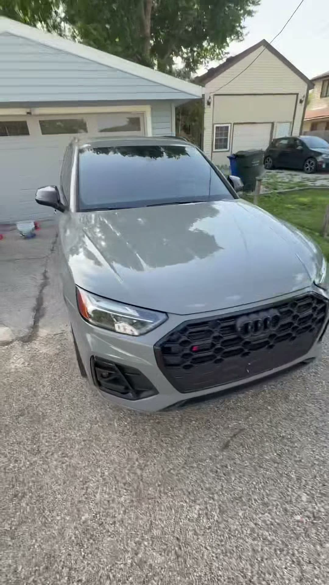 Gray Audi SUV at the driveway before the wash sequence