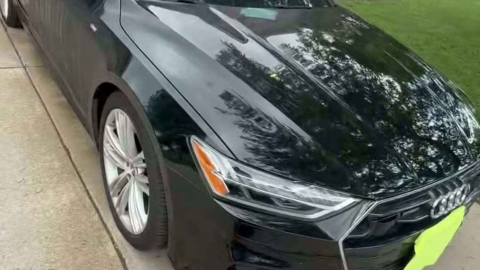 Glossy black Audi after an exterior detail in an Elgin-area driveway